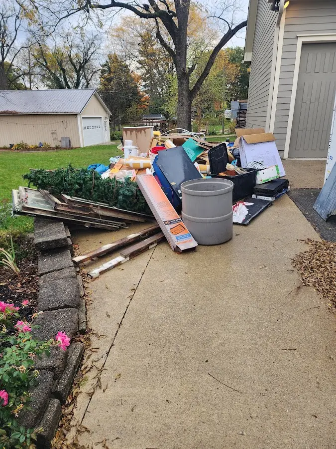Dumpster being loaded with debris for 3 Yard Dumpster Rental in Lonsdale